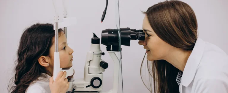 Oftalmologista examinando uma criança utilizando aparelho médico.